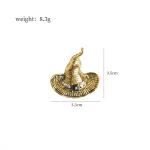 Detailed view of vintage gold witch hat brooch with black gem and crystal accents