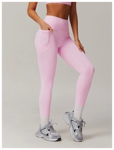 Detailed view of pink high-waisted yoga leggings featuring a practical side pocket for phone