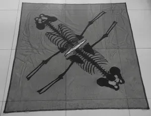 Detail showing black lace knit shawl with white skeleton pattern for Halloween party decor