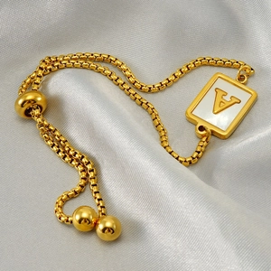 Adjustable gold pull-chain bracelet with square V-letter shell pendant on satin