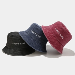 Washed cotton bucket hats in black, navy, and wine red with I DON'T CARE embroidery