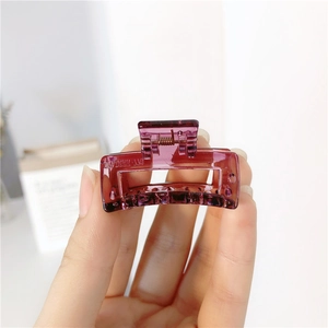 Detail of a dark purple translucent square hair claw clip with a durable metal spring