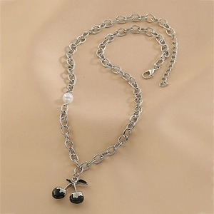 Close-up of hip hop silver chain necklace with black cherry pendant and white pearl detail