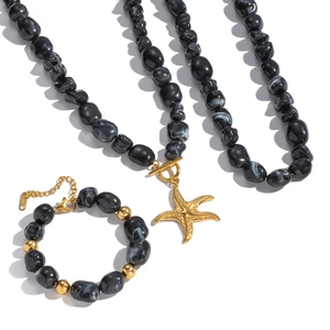 Irregular black resin bead necklace and bracelet set with golden starfish pendants