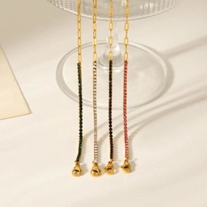 Detailed view of stainless steel cross chains with colorful zircon crystals in various shades