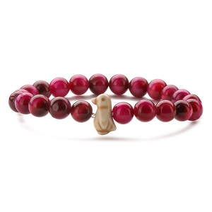 Detail of pink tiger eye beads stretch bracelet with an ivory penguin charm ornament