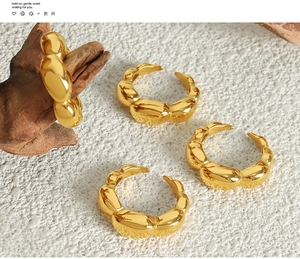 Close-up of gold-plated bamboo joint style open ring with irregular bubble texture