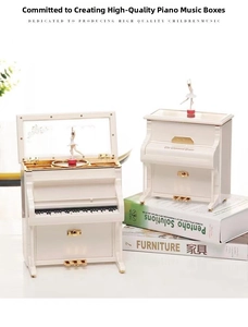 Detailed macro of white piano music box with golden accents and ballerina dancing on the mirror
