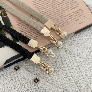 Elegant thin elastic waist belts in black and beige with gold metal buckle and pearl charms