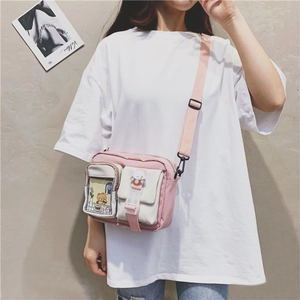 Detail of pink and beige canvas crossbody bag with multi-pockets and adjustable strap