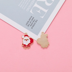 Macro detail of alloy Santa Claus enamel charms with red white gold finish for jewelry making