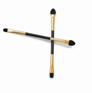 Dual-ended eyeshadow brush featuring soft fiber bristles and a sponge tip on gold ferrule