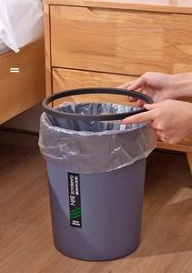 Detail showing the removable black retaining ring securing the trash bag in the grey bin