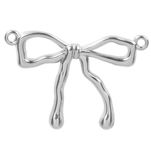 Detailed macro view of silver bow-shaped stainless steel pendant with connector loops