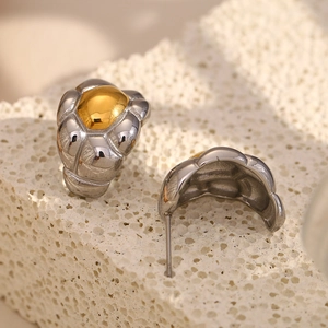 Close-up of two-tone 18K gold plated stainless steel stud earrings with quilted texture