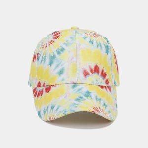 Detail of colorful tie-dye baseball cap featuring vibrant floral patterns and cotton texture