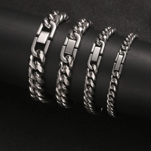 Macro shot of four different widths of silver Cuban link bracelets in titanium steel