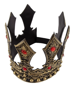 Macro detail of retro bronze king crown with intricate carvings and red gemstones