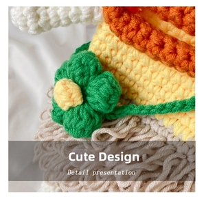 Macro shot of colorful handmade crochet texture with small green floral detail