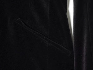 Close-up of side pocket stitching and high-quality velvet texture on black jumpsuit