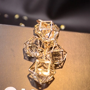 Golden geometric crystal keychain featuring hollow octahedron frames with clear zirconia