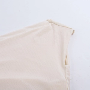 Close-up of the mesh knit texture and shoulder seam on an off-white one-shoulder dress