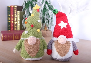 Close-up of knitted Christmas gnomes with plush beards and festive star decorations