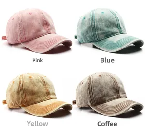 Detail view of four washed cotton baseball caps in pink, blue, yellow and brown colors