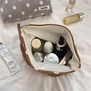Detailed top view of retro polka dot corduroy cosmetic bag showing spacious interior