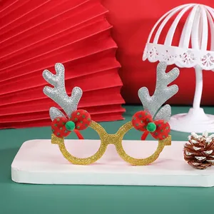 Glittery gold Christmas reindeer glasses with red bows for holiday party photo props
