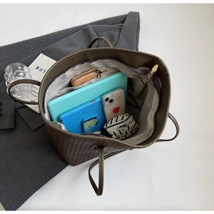 Brown woven tote bag showing large internal capacity for tablet, phone, and folding umbrella