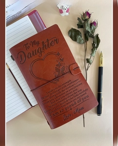 A6 brown leather journal with engraved message to daughter and vintage prop styling