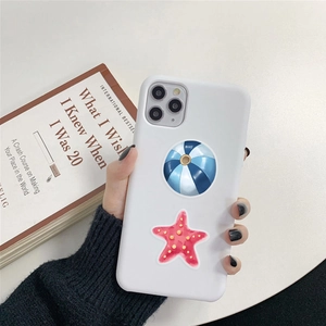 Detailed view of hand holding a white smartphone case with colorful starfish and beach ball prints