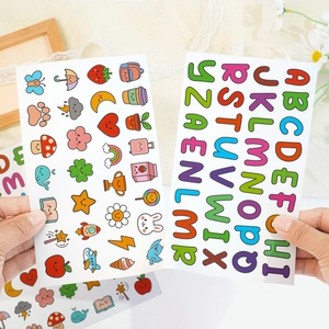 Detail of cute alphabet and cartoon stickers being held for DIY water bottle decoration