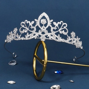 Detailed macro of silver alloy crown with sparkling rhinestones on a metal stand