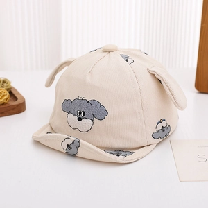 Detailed close-up of corduroy baby cap with puppy embroidery and 3D plush ears