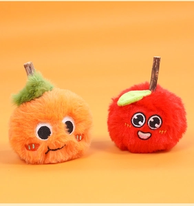 Detail of plush cat toys with fruit shapes, soft long fur, and cute cartoon embroidery