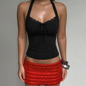 Detail of black lace halter top with bow and layered red fringe skirt on model