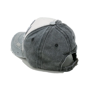 Close-up of distressed washed cotton baseball cap with vintage frayed edge details