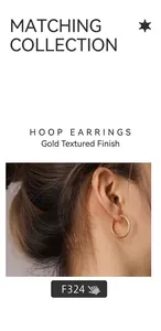 Close-up of golden round hoop earrings with textured finish worn by a model