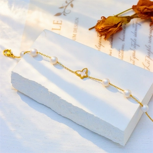 Elegant gold titanium steel bracelet with white pearls and butterfly shell pendant