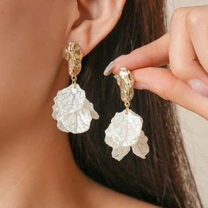Vintage acrylic petal tassel earrings with textured white flowers and gold finish