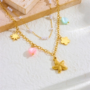 Double-layered gold ocean necklace with starfish, flower pendants and small pearls