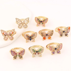 Macro shot of multiple gold butterfly rings with colorful cubic zirconia stones