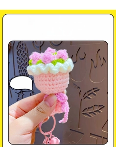 Close-up of handmade crochet pink rose bouquet pendant with pink bell and lobster clasp