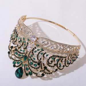 Close-up of gold tiara featuring emerald green water-drop gems and crystal details