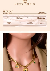 Detail of gold titanium steel necklace with heart and evil eye pendants on model
