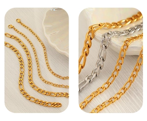 Detail of gold and silver Figaro chain bracelets in various widths on shell decor