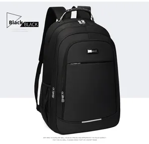 Detail view of water-resistant black nylon business backpack with metal logo and reinforced handle