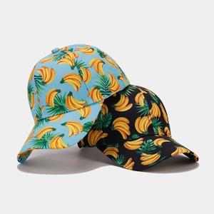 Close-up of tropical banana and leaf print on cotton baseball caps in blue and black